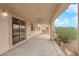 Covered patio with ceiling fans, providing a comfortable outdoor living space overlooking the yard at 4029 Ricebird Way, North Las Vegas, NV 89084