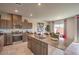 Modern kitchen featuring stainless appliances, island with granite countertop, and breakfast bar at 4445 Bayley Skye Ave # 106, Las Vegas, NV 89141