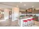 Bright open kitchen featuring a large island, stainless steel appliances, and tile flooring at 4445 Bayley Skye Ave # 106, Las Vegas, NV 89141
