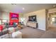 Spacious living room featuring theater decor, comfortable seating, and plush carpet at 4445 Bayley Skye Ave # 106, Las Vegas, NV 89141