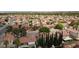 This is an aerial view of a neighborhood with many houses and tree lined streets in the city at 4732 Illustrious St, Las Vegas, NV 89147