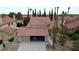 Aerial view of a home showcasing the red tile roof, desert landscaping, and attached garage at 4732 Illustrious St, Las Vegas, NV 89147