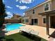 Backyard showcasing a private pool, lounge chairs, and outdoor dining area at 4732 Illustrious St, Las Vegas, NV 89147