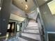 Grand entryway featuring a winding staircase, grey walls, and marble floors at 4732 Illustrious St, Las Vegas, NV 89147