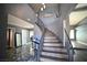Grand entryway featuring a winding staircase, grey walls, and marble floors at 4732 Illustrious St, Las Vegas, NV 89147