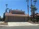 Charming two-story home featuring a terracotta roof, three-car garage, and desert landscaping with palm trees at 4732 Illustrious St, Las Vegas, NV 89147