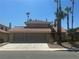 Two-story home with a terracotta roof, desert landscaping, and a two-car garage at 4732 Illustrious St, Las Vegas, NV 89147