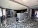 Eat in kitchen featuring modern appliances, barstool seating and updated flooring at 4732 Illustrious St, Las Vegas, NV 89147