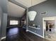 Open-concept living and dining area features hardwood floors, neutral paint, and modern lighting fixture at 4732 Illustrious St, Las Vegas, NV 89147