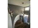 Modern staircase featuring wooden steps and a decorative light fixture at 4732 Illustrious St, Las Vegas, NV 89147