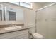 Bathroom with a shower, toilet, a granite vanity with a decorative mirror, and an overhead light at 4889 W Montara Cir, Las Vegas, NV 89121