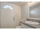 Bathroom featuring a granite vanity, toilet, decorative mirror, and a door to the exterior at 4889 W Montara Cir, Las Vegas, NV 89121