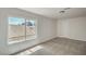 Bright bedroom with large window, plush carpeting, and neutral paint scheme at 4889 W Montara Cir, Las Vegas, NV 89121