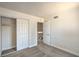 Carpeted bedroom with closet, neutral paint, and classic door at 4889 W Montara Cir, Las Vegas, NV 89121