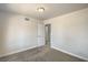 Neutral bedroom with plush carpeting, bright window, and a classic door at 4889 W Montara Cir, Las Vegas, NV 89121