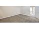 Clean bedroom with neutral walls, patterned carpet, and doorway leading to other parts of the home at 4889 W Montara Cir, Las Vegas, NV 89121