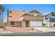 Exterior view of a home with a two-car garage and balcony at 4889 W Montara Cir, Las Vegas, NV 89121