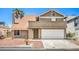 Charming home featuring a two-car garage, desert landscaping, and a classic facade at 4889 W Montara Cir, Las Vegas, NV 89121