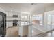 Bright kitchen with granite countertops, an island, stainless steel appliances, and backyard access at 4889 W Montara Cir, Las Vegas, NV 89121