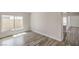 Spacious, light-filled living room with wood flooring and large windows at 4889 W Montara Cir, Las Vegas, NV 89121