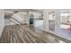 Bright living room open to staircase, kitchen, and outdoor patio at 4889 W Montara Cir, Las Vegas, NV 89121
