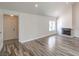 Living room featuring fireplace, wood floors, and entry to another room at 4889 W Montara Cir, Las Vegas, NV 89121
