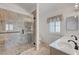 Updated bathroom features a large glass shower and dual sinks at 4924 Cedar Lawn Way, Las Vegas, NV 89130