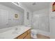 Bright bathroom featuring a vanity with mirror and a shower and tub with swan themed sliding doors at 4924 Cedar Lawn Way, Las Vegas, NV 89130
