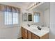 Bathroom with double sinks, large mirror, and good lighting at 4924 Cedar Lawn Way, Las Vegas, NV 89130