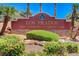 The Los Prados Golf Community and Country Club sign framed by mature trees and vibrant landscaping at 4924 Cedar Lawn Way, Las Vegas, NV 89130