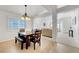 Bright dining room with a wooden table, stylish lighting, and an open layout at 4924 Cedar Lawn Way, Las Vegas, NV 89130