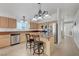 Well-lit kitchen featuring stainless steel appliances, island, and breakfast bar seating at 4924 Cedar Lawn Way, Las Vegas, NV 89130