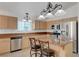 Kitchen with stainless steel appliances, island with breakfast bar, and natural light at 4924 Cedar Lawn Way, Las Vegas, NV 89130