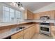 Kitchen featuring a stainless steel sink, oven, and a window with natural light at 4924 Cedar Lawn Way, Las Vegas, NV 89130