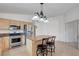 Open kitchen featuring stainless steel appliances and a central island with barstool seating at 4924 Cedar Lawn Way, Las Vegas, NV 89130
