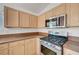 Close-up shot of kitchen cabinets and stainless steel oven and microwave appliance at 4924 Cedar Lawn Way, Las Vegas, NV 89130