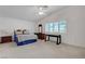 Spacious main bedroom featuring large windows, a ceiling fan, and neutral carpet at 4924 Cedar Lawn Way, Las Vegas, NV 89130