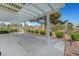 Large covered patio overlooking manicured landscaping with plenty of space for relaxing and enjoying the outdoors at 4924 Cedar Lawn Way, Las Vegas, NV 89130