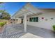 Inviting covered patio with charming butterfly accents and well-maintained landscaping for outdoor enjoyment at 4924 Cedar Lawn Way, Las Vegas, NV 89130