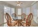 Bright breakfast nook with a glass table, four chairs, and natural light at 5124 Appealing Ct, Las Vegas, NV 89130