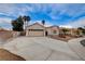 A well-manicured front yard shows a charming single-story home with desert landscaping, and a two-car garage at 5124 Appealing Ct, Las Vegas, NV 89130