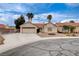 Charming single-story home features desert landscaping, a brick fire pit, and a two-car garage at 5124 Appealing Ct, Las Vegas, NV 89130