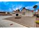 A well-maintained front yard shows a home with desert landscaping and a charming brick fire pit at 5124 Appealing Ct, Las Vegas, NV 89130