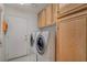 Laundry room with a washer, dryer, storage cabinets, and easy access to outside at 5124 Appealing Ct, Las Vegas, NV 89130