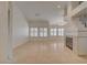 Open-concept living room features tile floors, a modern fireplace, and multiple windows with plantation shutters at 5124 Appealing Ct, Las Vegas, NV 89130