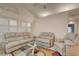 Open living room with large windows, vaulted ceilings, and comfortable furnishings at 5124 Appealing Ct, Las Vegas, NV 89130