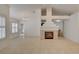 Open living area features neutral tile floors, a modern fireplace, and abundant natural light at 5124 Appealing Ct, Las Vegas, NV 89130