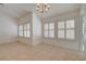Open living area with tile flooring, a modern chandelier, and multiple windows with plantation shutters at 5124 Appealing Ct, Las Vegas, NV 89130