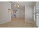 Bright and airy living room featuring tile floors, a chandelier, and multiple entryways at 5124 Appealing Ct, Las Vegas, NV 89130