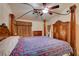 Comfortable main bedroom features a wooden four-poster bed and an elegant ceiling fan at 5124 Appealing Ct, Las Vegas, NV 89130